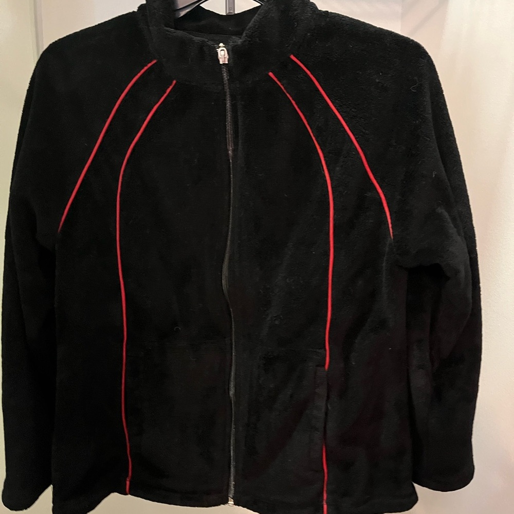 Black fleece jacket with red strip detail. Size M